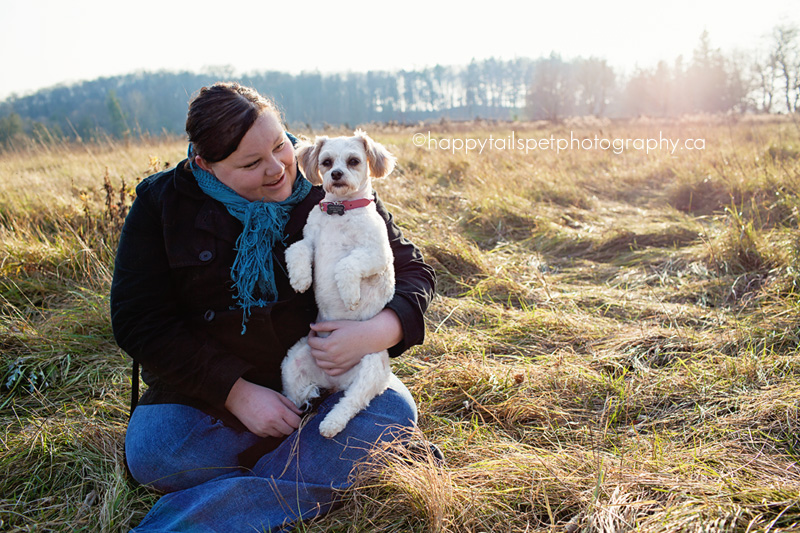 Small dog and owner in Ontario field with soft light.