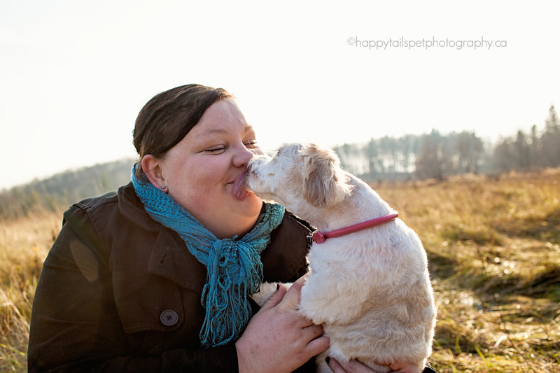 Dog kisses owner at Ontario pet photography session at Scottsdale Farm in Georgetown.