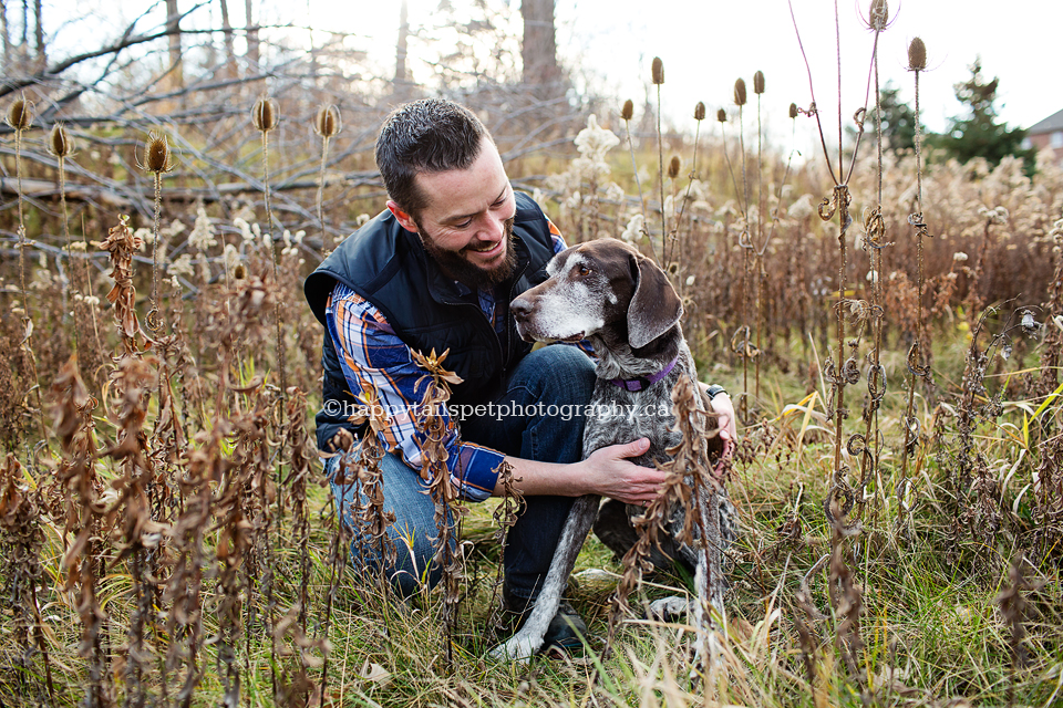 Sweet photo of a senior dog and man in beautiful outdoor field in Halton Region.