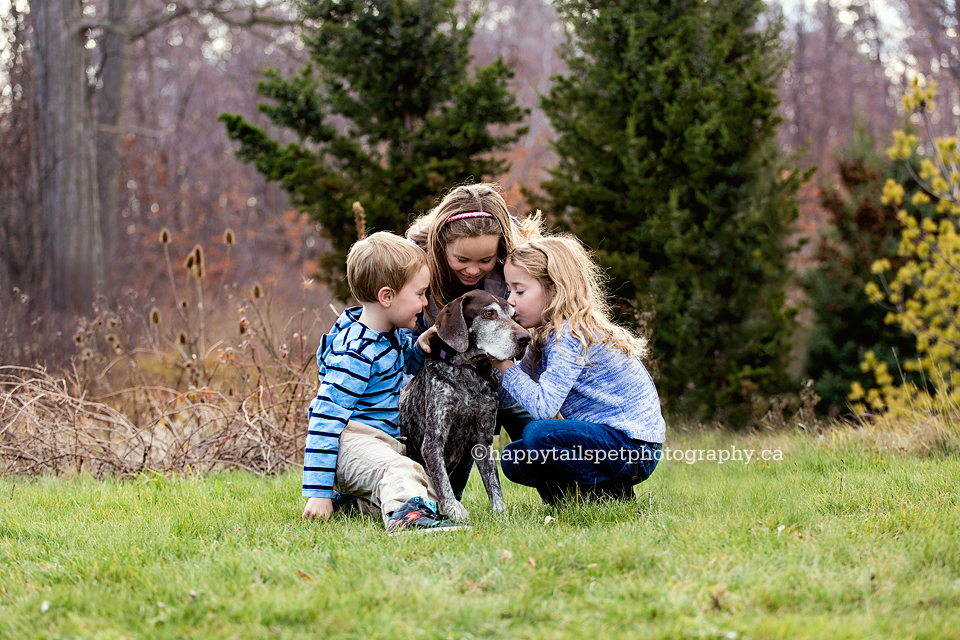 Kids show love to family dog by Burlington pet and family photographer.