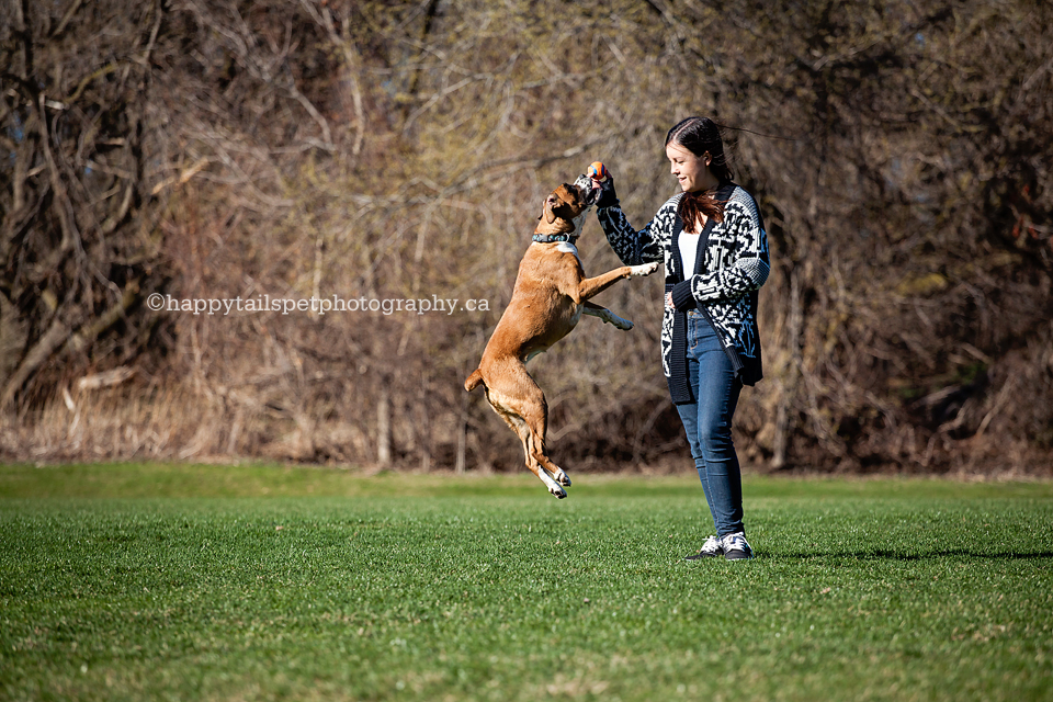 Girl plays with her dog in Ontario park.