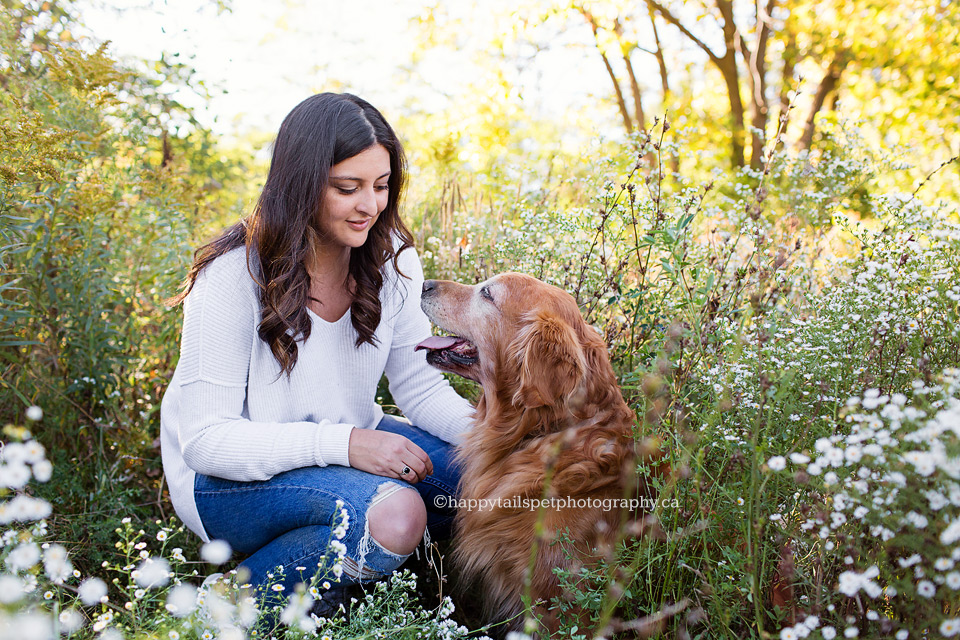 Photo of girl and her dog in the flowers along a Burlington trail.