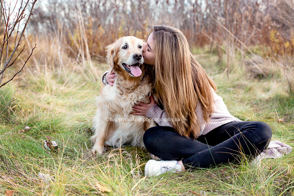 A girl kisses her dog in photo by Burlington pet photographer.