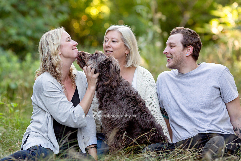 Dog licks woman's face in photo by Ontario pet photographer.